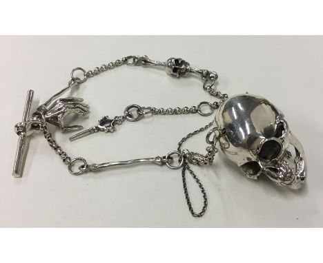 A novelty silver pendant in the form of a skull on fancy link chain. Approx. 57 grams. Est. £100 - £150.