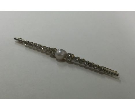 A large pearl and diamond brooch with rubover mount set in gold and platinum. Approx. 5.5 grams. Est. £600 - £800.