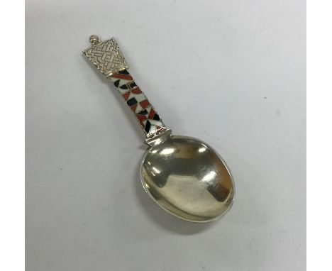 A silver and enamel caddy spoon of tapering form. Approx. 20 grams. Est. £40 - £60.
