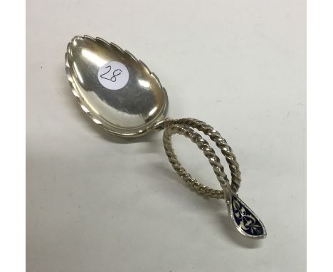 A large silver gilt and enamel caddy spoon with swirl decoration. Approx. 34 grams. Est. £40 - £60.,