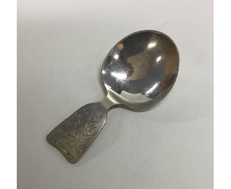 A Danish silver caddy spoon with floral decoration. Approx. 25 grams. Est. £30 - £50.