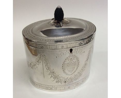 A good quality George III bright cut silver tea caddy with crested front to pineapple finial. London 1784. By John Lambe. App