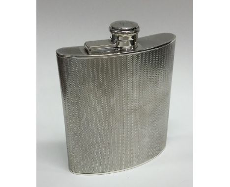 A large silver engine turned hip flask with hinged top. Birmingham. By AW. Approx. 225 grams. Est. £100 - £150.