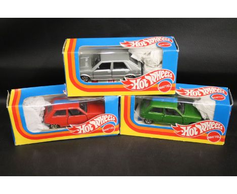 Three boxed Mattel Hot Wheels 1/43 diecast vehicles to include two Renault 5 TL A-69, one green, one red and Lancia Delta in 