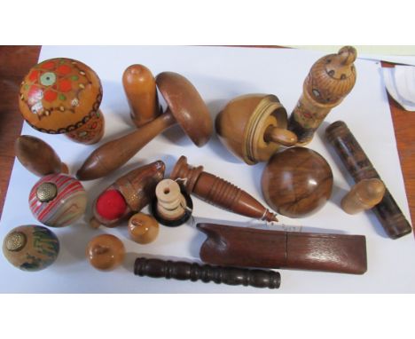 A collection of wooden sewing related items, to include darning mushrooms, bobbin cases etc