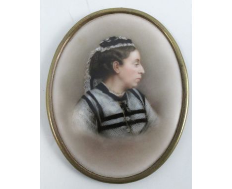 A 19th century oval porcelain plaque, decorated with a portrait of a woman wearing black and white, in a silver plated frame,