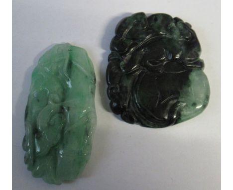 Two green jade style discs, one carved with a mythical beast, the other with foliage, height 2ins and 2.5ins