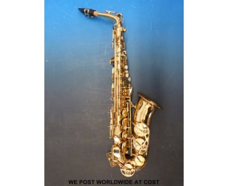 A cased 'Odyssey' Alto saxophone together with stand and a Maelzel Paquet metronome