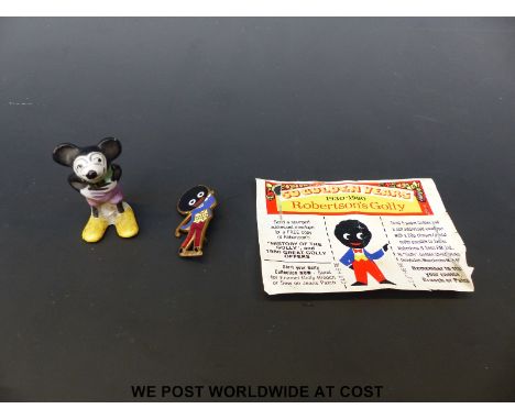 Early ceramic Mickey Mouse figure together with a vintage Robertson's Golly badge