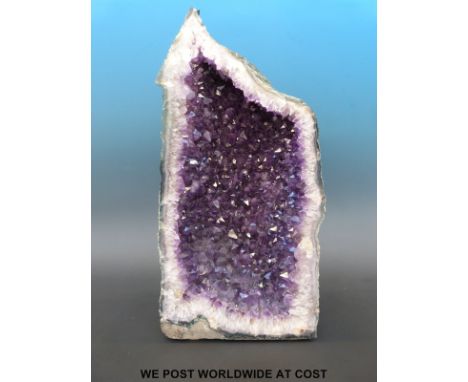 An amethyst quartz "Cathedral" formation freestanding geode with deep colouring (47cm tall, 24cm wide)