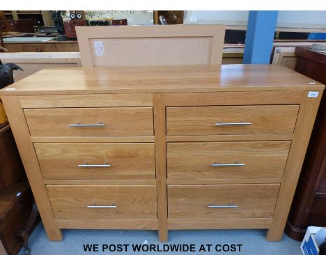 A contemporary light oak chest of six graduated drawers 