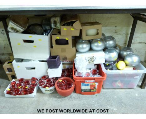 A large quantity of night light holders together with night lights and candles