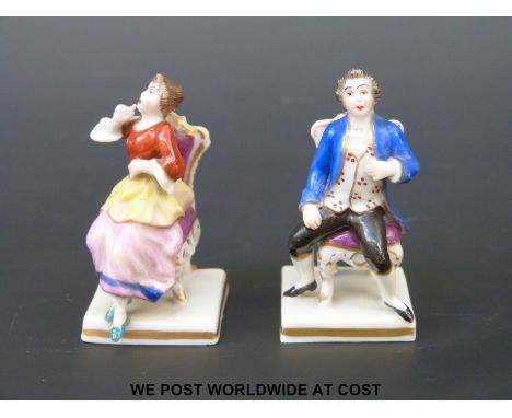 A pair of Dresden style miniature porcelain figures