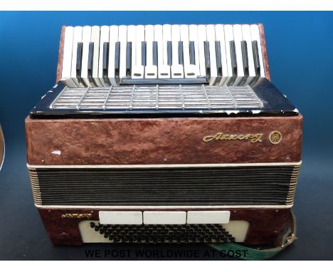 An Akkorpg Russian piano accordion with 96 bass buttons, five treble couplers and three bass couplers, in pink pearloid finis