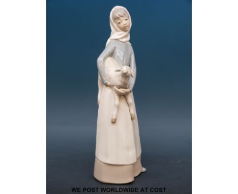 A Lladro figure of a girl with lamb