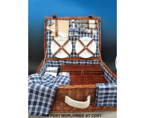 A wicker picnic hamper complete with contents
