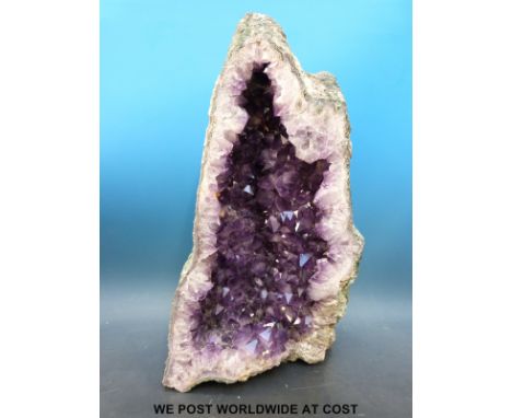 An amethyst quartz "Cathedral" formation freestanding geode with deep colouring (66cm tall, 40cm wide)