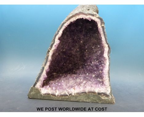 An amethyst quartz "Cathedral" formation freestanding geode (33cm tall, 27cm wide)