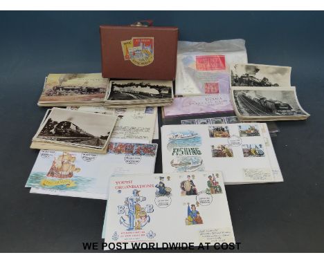 A leather box of locomotive postcards together with a selection of British first day covers from the 1980's