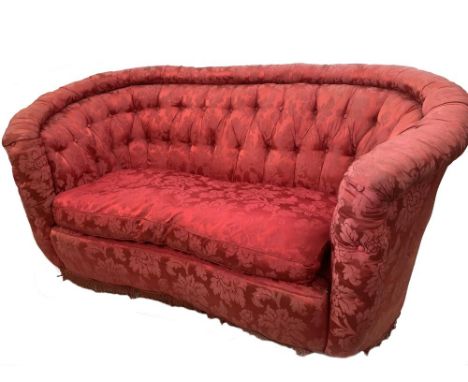 A sofa of concave outline, button upholstered in a dark crimson silk damask fabric, with a loose cushion seat, 75cm (29.5in) 