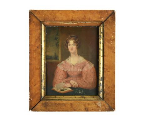 English Provincial School, 18th Century  Portrait of a lady, seated, in a pink sprigged dress and lace fichu, reading a book,