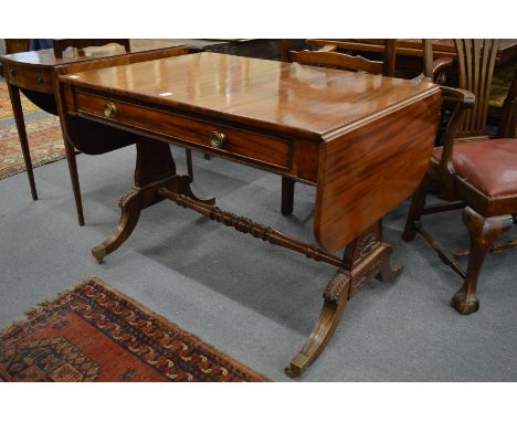 A good early 19th century mahogany sofa table with single frieze drawer on carved end supports united by a turned stretcher o