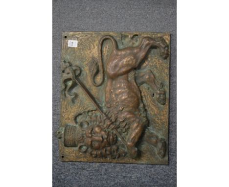 A good heavy relief cast bronze plaque depicting a lion passant carrying a banner upon its shoulder.