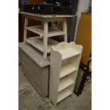 A painted three tier table and a book shelf.