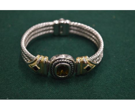 A silver bangle.
