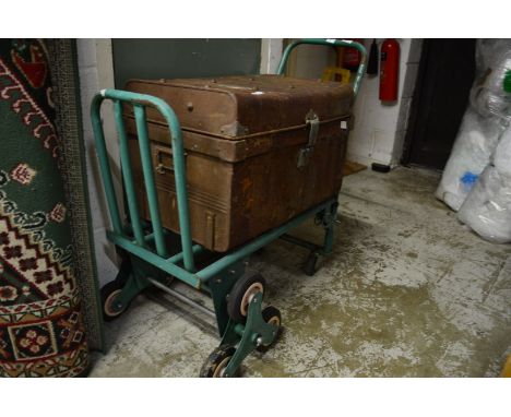 A folding stair walker sack trolley/truck together with a tin trunk.