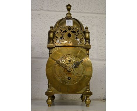A reproduction brass lantern clock.