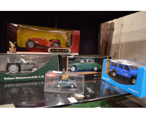 Five boxed model cars etc.