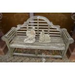 A Lutyens style hardwood garden bench.