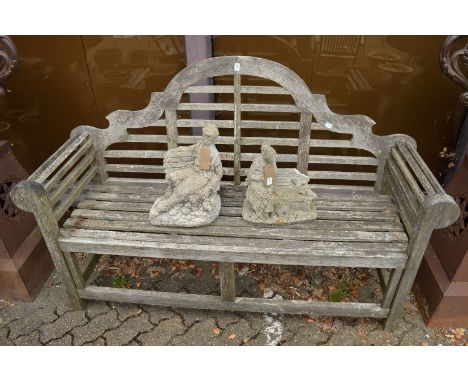 A Lutyens style hardwood garden bench.