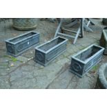 Three faux lead rectangular shaped garden planters.