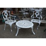 A pair of white painted aluminium garden chairs and a similar circular coffee table.