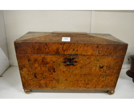 A burr wood sarcophagus shaped tea caddy.