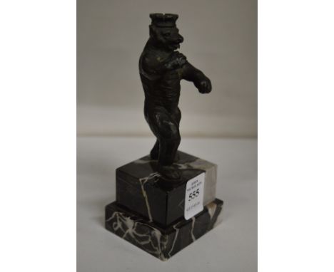 A small bronze of a standing bear wearing a crown on a marble base.