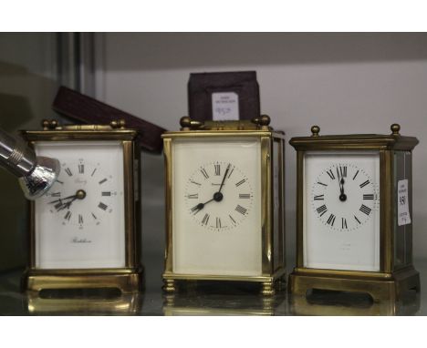 Three carriage clocks and a carriage clock case.