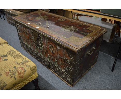 A good Eastern brass bound hardwood trunk with brass studded decoration and three drawers to the base.