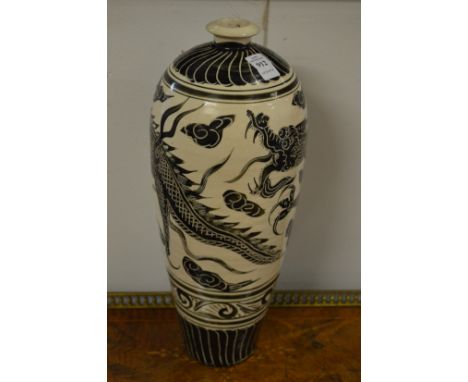 A Chinese tall pottery vase with incised dragon decoration.
