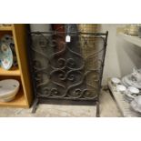Wrought iron fire guard.