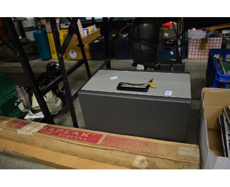 A projector, photographic enlarger, folding screens and a sewing machine.