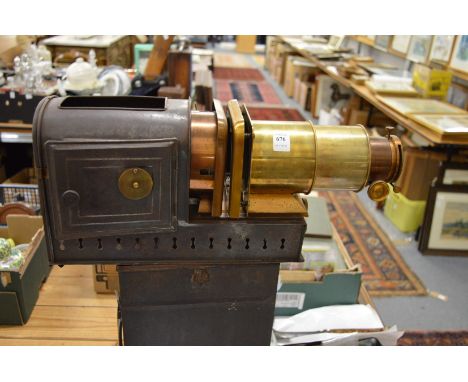 An early brass and black japanned projector in original case.
