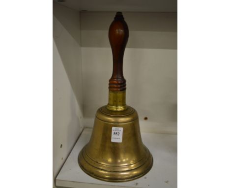 A large bronze hand bell.