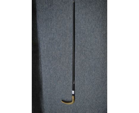 A good horn handled and gilt metal mounted walking stick.