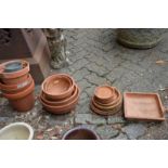 Terracotta plant pots with stands.