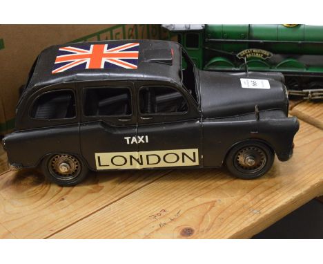 Tin plate model of a black taxi.