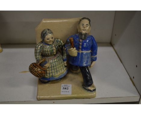 An unusual pottery model of a man and a women.