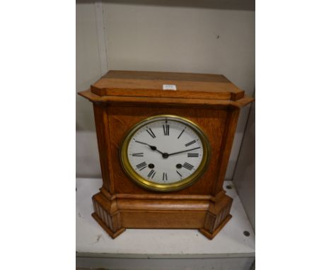 An oak cased mantel clock.
